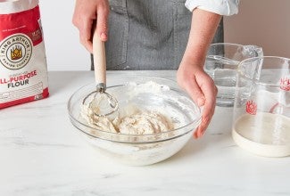 Mixing together sourdough starter to feed it